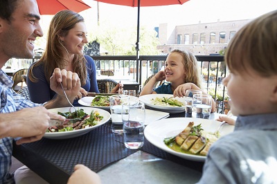 Family Enjoying Meal At Outdoor Restaurant