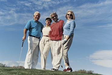 Portrait of Four People Standing in a Line on a Golf Course