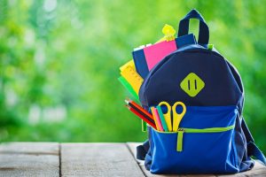 Full School backpack on wooden and nature background