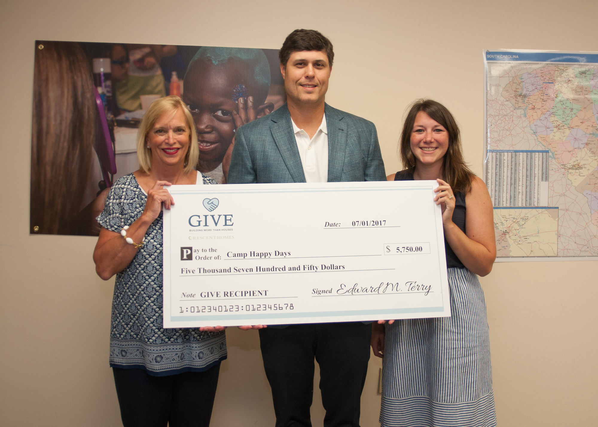 Ted Terry presents a check to Camp Happy Days